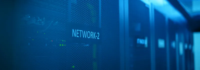 Aisle of blue-lit server racks inside a datacenter
